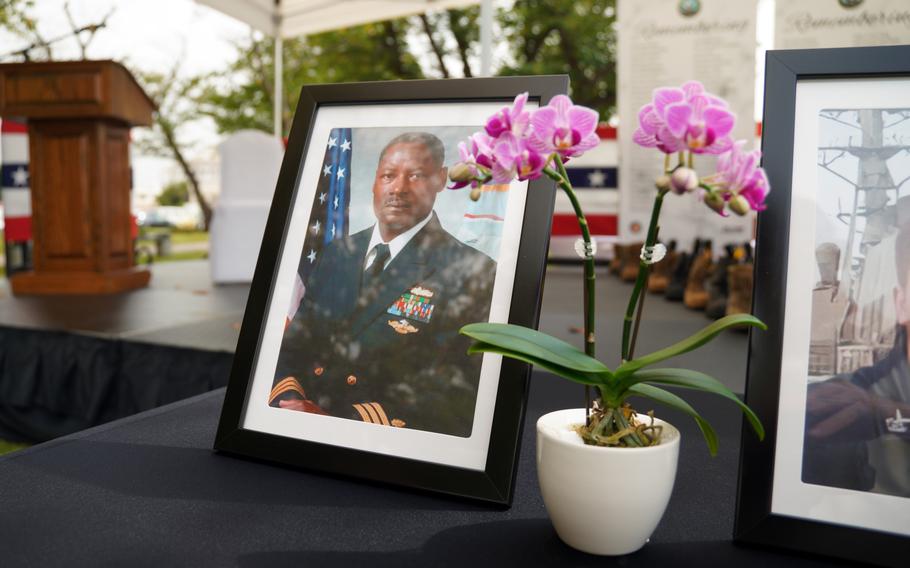 Photos of deceased sailors are displayed during the Bells Across America ceremony at Yokosuka Naval Base, Japan, Thursday, Sept. 19, 2024.