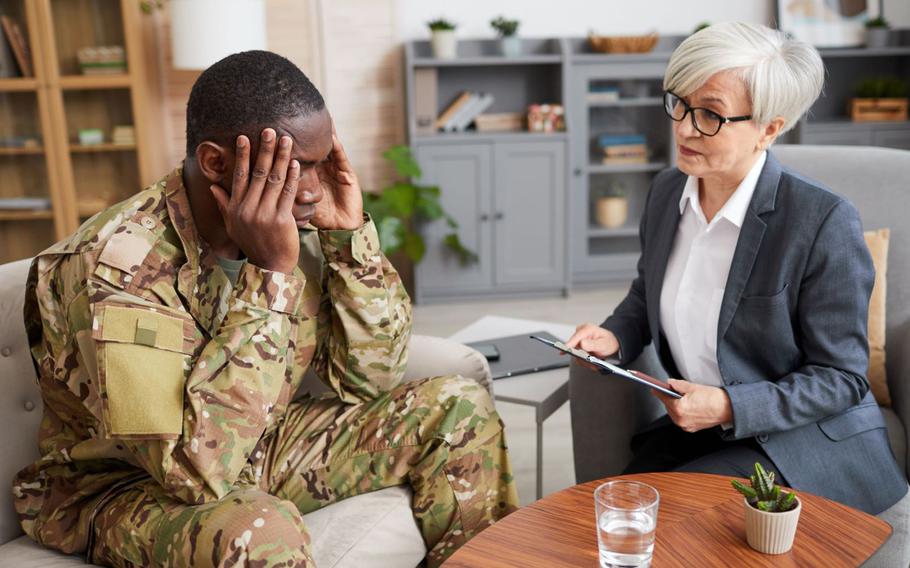 A soldier sits with a therapist