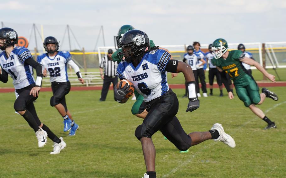 Trevon Scott runs with the football.