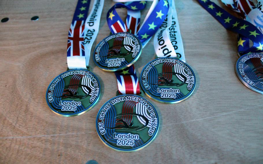 Medals await recipients on a table.