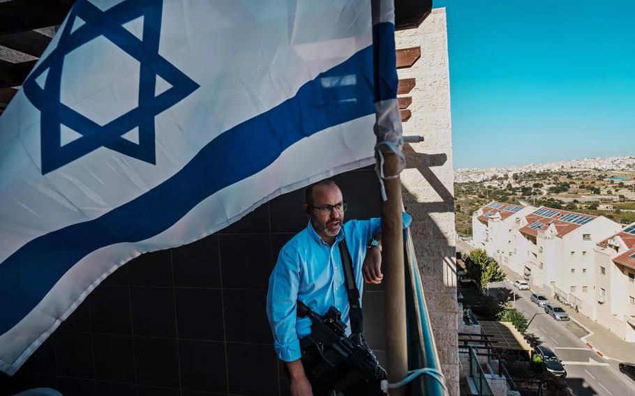 Tzvika Mor speaks during a phone interview with a radio station at his home in Kiryat Arba, an Israeli settlement that neighbors Hebron in the occupied West Bank. Mor’s 23-year-old son, Eitan, was kidnapped by Hamas militants on Oct. 7, 2023.