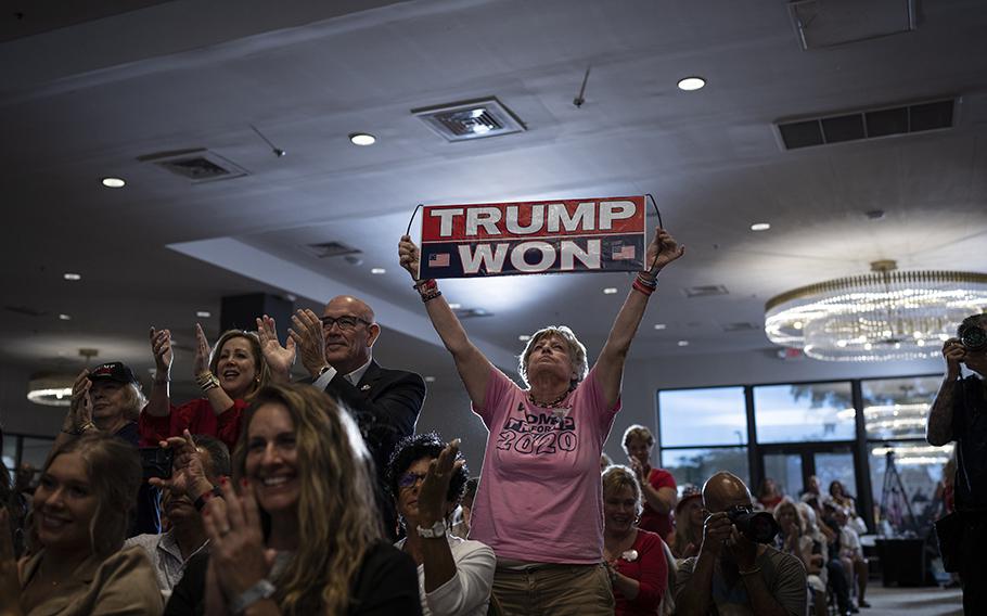A woman holds a sign, referring to the 2020 presidential election, at the pro-Trump rally led by Kari Lake, a former Arizona gubernatorial candidate.