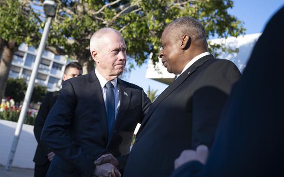 The U.S. Secretary of Defense shakes hands with the Israeli Minister of Defense during a meeting in Israel.