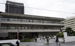 Reporters covering a U.S. airman’s trial on sexual assault and kidnapping charges wait outside Naha District Court on Okinawa, Oct. 25, 2024.