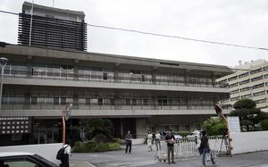 Reporters covering a U.S. airman’s trial on sexual assault and kidnapping charges wait outside Naha District Court on Okinawa, Oct. 25, 2024.