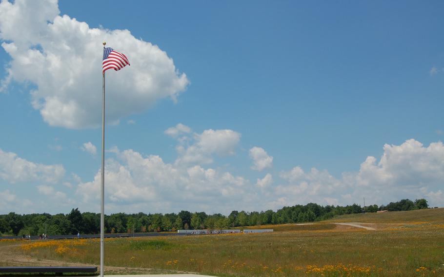 The American flag flies at the Memorial Plaza at the Flight 93 National Memorial with the Wall of Names in the distance. A nonprofit has launched a campaign to develop Patriot Park, a tribute to service members who have given their lives during the global war on terrorism, within the park's boundaries.