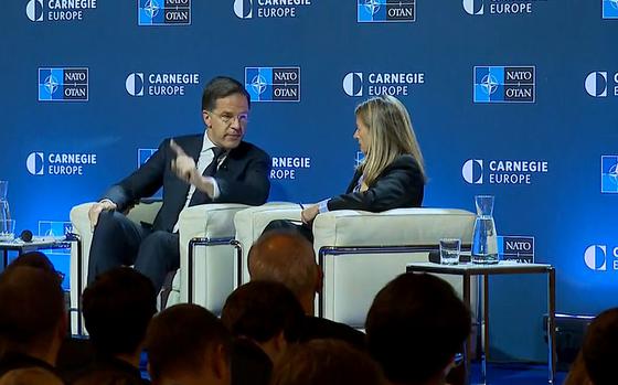 NATO Secretary-General Mark Rutte speaks with Rosa Balfour, director of the Carnegie Europe think tank, in Brussels on Dec. 12, 2024. In a speech the day before, Rutte urged Europeans and Canadians to start calling on their governments to raise defense spending.