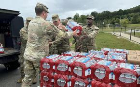 North Carolina soldiers pack up water and food to deliver in the aftermath of Hurricane Helene.