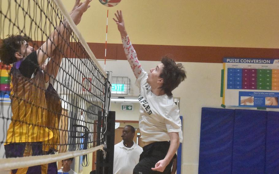 Naples’ Damon Bailey tries to tap the ball over the Bahrain first-line defense Thursday, Oct. 23, 2023, at the DODEA-Europe boys volleyball championships.