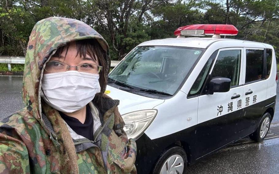 Anti-U.S. base protester Akino Miyagi poses with police vehicles on Okinawa in this undated photo posted to her Facebook account. 