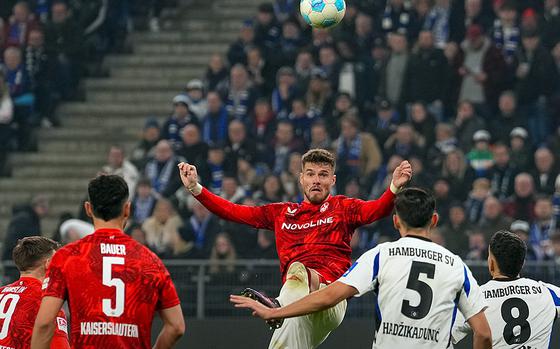 A FCK player tries to kick a soccer ball.