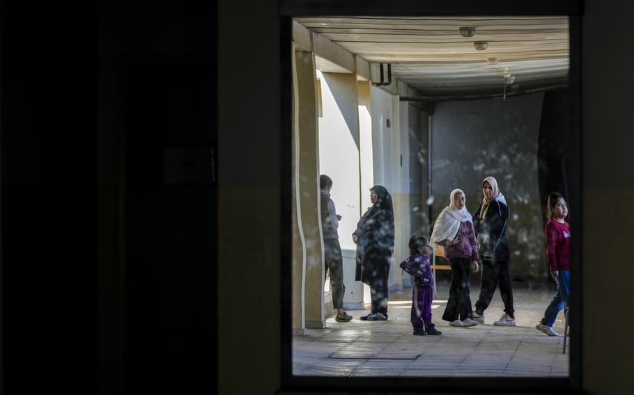 Displaced children, who fled Baalbek city and the nearby towns of Douris and Ain Bourday with their families amid the ongoing Hezbollah-Israel war, are reflected in a mirror inside a school