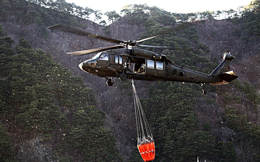 A UH-60 Black Hawk helicopter crew from the 2nd Infantry Division uses a Bambi Bucket to drop water on a wildfire in Gangwon province, South Korea, April 5, 2019. 