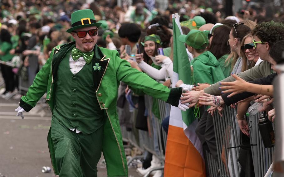 A man dressed as a leprachaun during a parade.