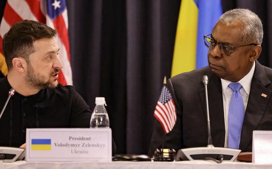 Ukraine's President Volodymyr Zelensky, left, and U.S. Secretary of Defense Lloyd Austin react during the opening of the Ukraine Defense Contact Group meeting at Ramstein Air Base, Germany, on Jan. 9, 2025. (Daniel Roland/AFP/Getty Images/TNS)