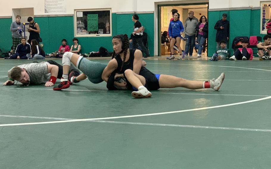 Rota’s Quennette Kirkconnell, top, works to pin opponent  Vivian Cortez of Ankara during a final match in the girls 105-pound class at Saturday’s DODEA Southern Europe wrestling sectionals at Naples Middle High School in Naples, Italy.