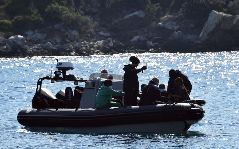 Survivors sit on a vessel