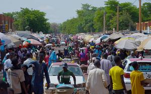Pedestrian shops at a market in Niamey, Niger, Wednesday, July. 24, 2024. One year has passed since a dramatic coup in Niger.  (AP Photo/Omar Hama)