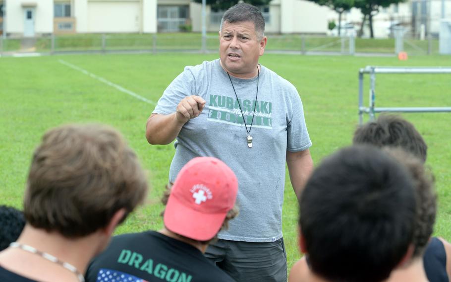 Coach Tony Alvarado makes his point during Kubasaki's initial football practice on Monday.