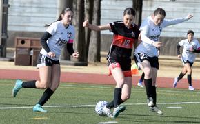 Joanna Hall of E.J. King High School tries to dribble between McKenzie Steele, left, and Priscilla Ramirez of Matthew C. Perry during a tournament at Yokota Air Base, Japan, Feb. 28, 2025.