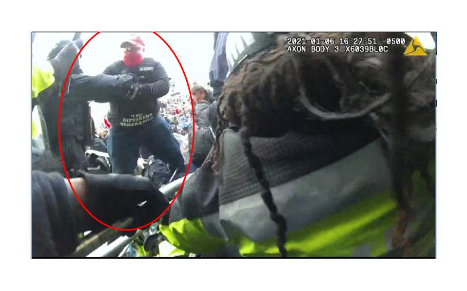 A screen grab from body-camera video shows Ronald McAbee, in a red circle added by investigators, during an assault on D.C. police officer Andrew Wayte at the Capitol on Jan. 6, 2021. 