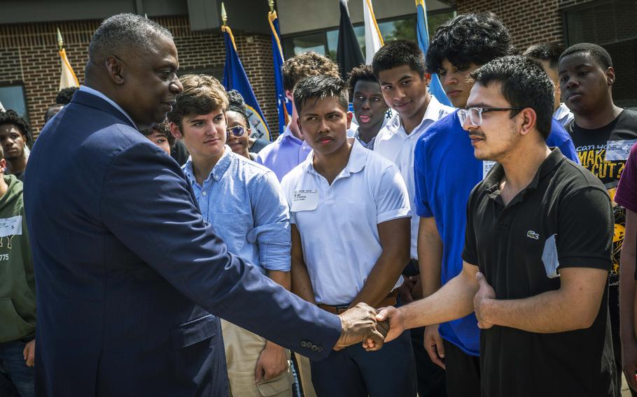 Defense Secretary Lloyd Austin congratulates new recruits at the Baltimore Military Entrance Processing Station after administering the oath of enlistment, Wednesday, July 5, 2023, at Fort Meade, Md.