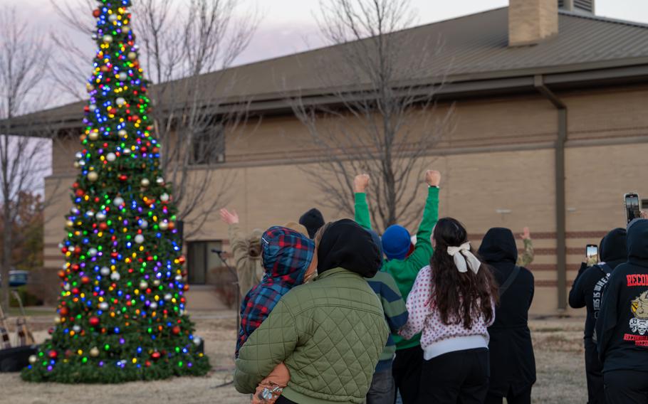 People watch as the Christmas tree lights up at McConnell Air Force Base.