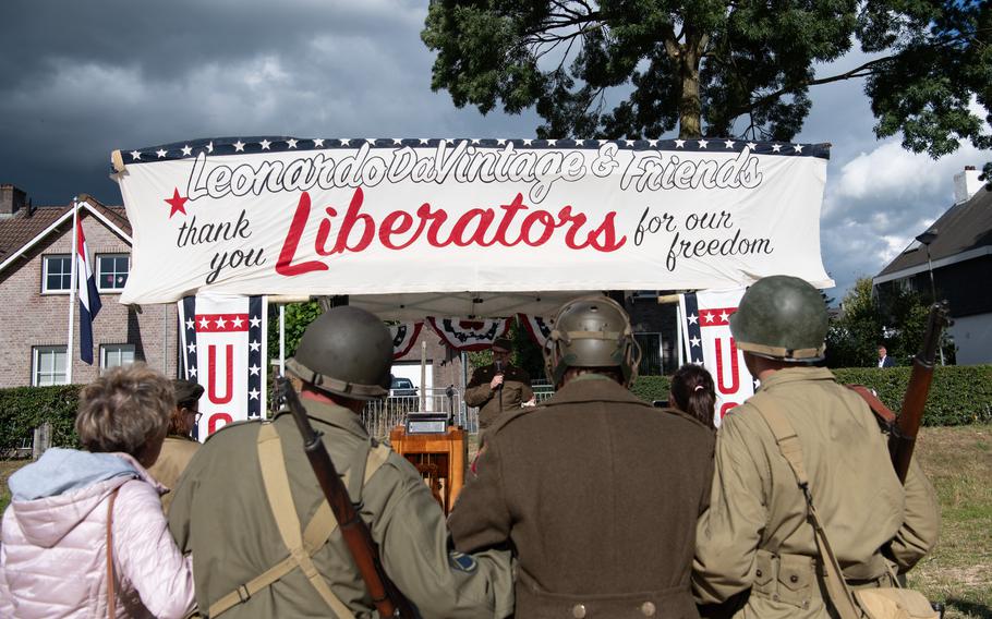 World War II reenactors dance at a ceremony in Mesch