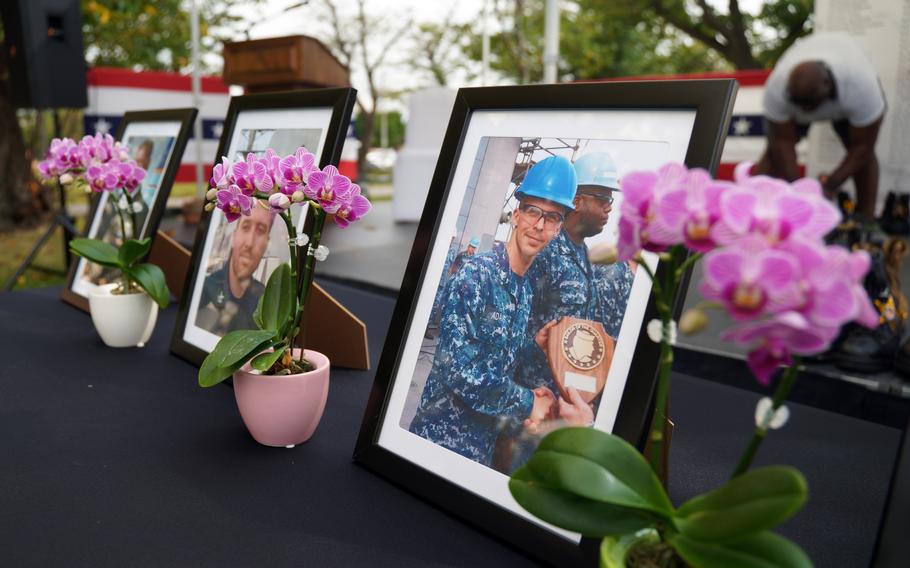 Photos of deceased sailors are displayed during the Bells Across America ceremony at Yokosuka Naval Base, Japan, Thursday, Sept. 19, 2024.