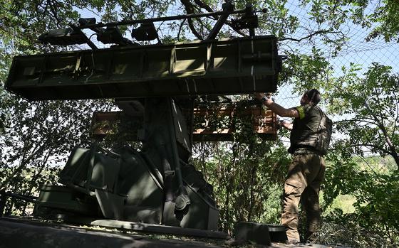 Ukrainian soldiers stand by a missile system, June 11, 2024.