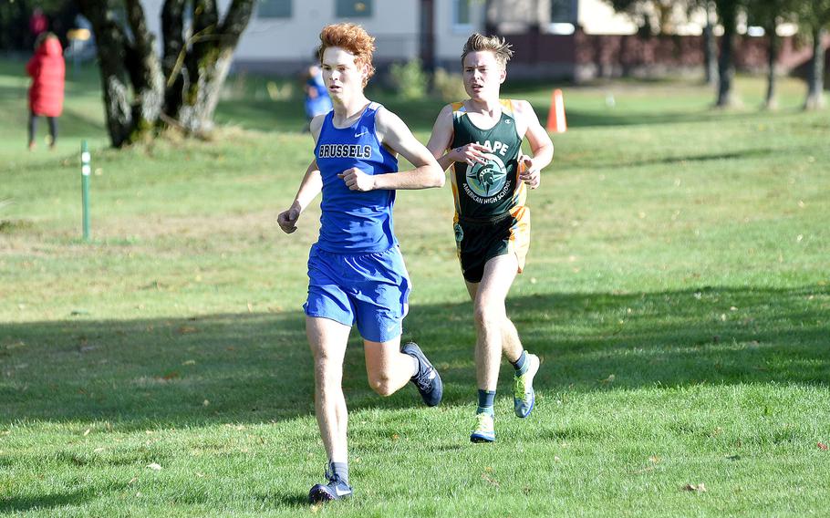 Brussels senior Cade Wedekind runs ahead of SHAPE's David VanWagenen during a race at Rolling Hills Golf Course on Oct. 14, 2023, in Baumholder, Germany.