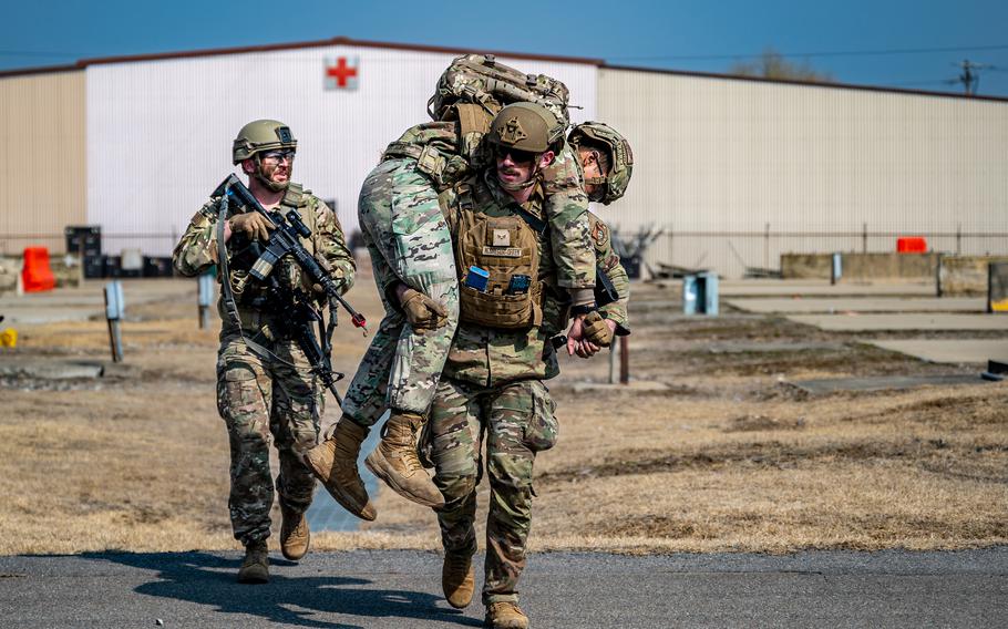 Senior Airman Ethan McGregor, an aircraft parts store journeyman for the 51st Logistics Readiness Squadron, carries a mock casualty to safety during a Combat Readiness Course at Osan Air Base, South Korea, March 14, 2024. 