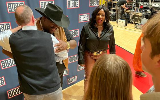 Country duo The War and Treaty meets fans in front of a USO backdrop.