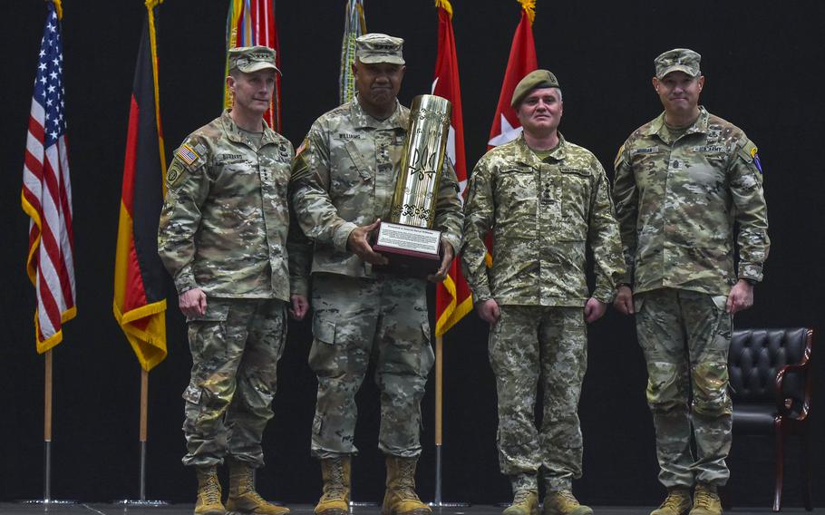 An artillery round fired by Ukrainian forces is presented to Gen. Darryl Williams at a change of command ceremony