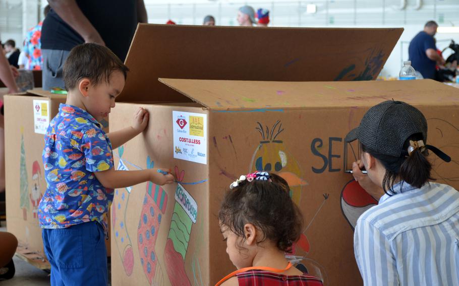 Volunteers helped prepare boxes for Operation Christmas Drop at Andersen Air Force.