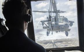 240811-N-WV584-1229 PACIFIC OCEAN (August 11, 2024) Lt. j.g. Austin Morretta from Medford, N.Y., watches from the flight deck tower as an MH-60S Sea Hawk helicopter, assigned to Helicopter Sea Combat Squadron (HSC) 14, lands on the flightdeck of the Arleigh Burke-class guided-missile destroyer USS Spruance (DDG 111). Spruance, assigned to the Abraham Lincoln Carrier Strike Group, is underway conducting routine operations in the U.S. 7th Fleet area of operations. U.S. 7th Fleet is the U.S. Navy’s largest forward-deployed numbered fleet, and routinely interacts and operates with allies and partners in preserving a free and open Indo-Pacific region. (U.S. Navy photo by Mass Communication Specialist Seaman Joey Sitter)