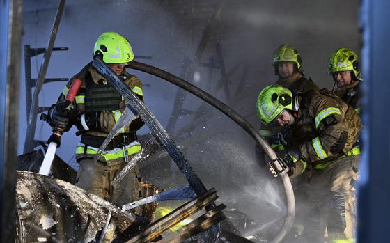 Ukrainian rescuers work to extinguish a fire in a building following a drone attack in Kyiv on Nov. 7, 2024. (Genya Savilov/AFP/Getty Images/TNS)