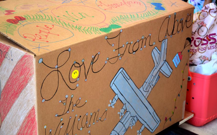 Personalized messages decorate boxes carrying gifts and supplies for Operation Christmas Drop. 