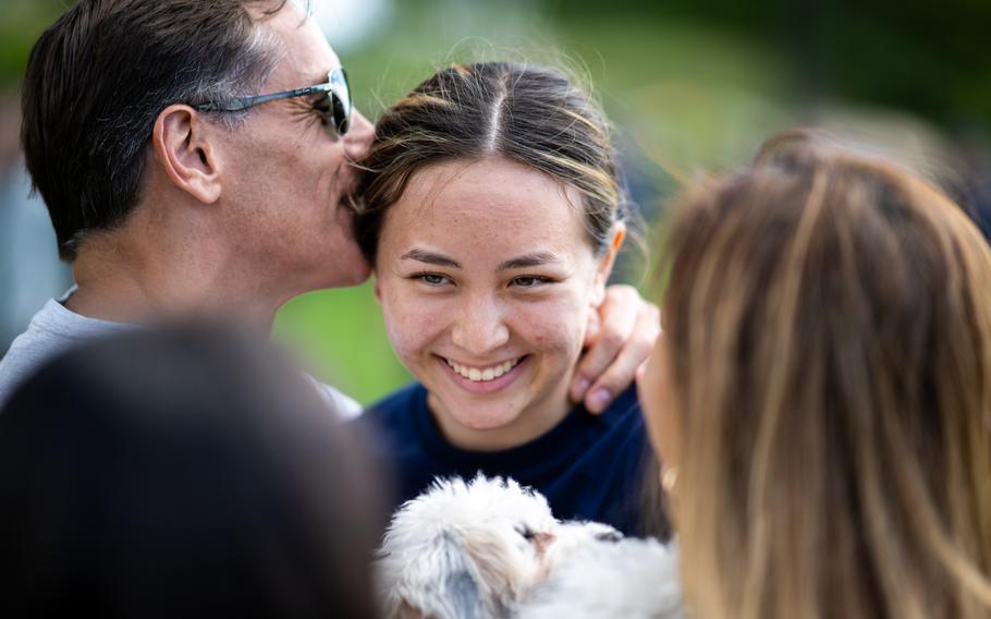 A member of the Coast Guard Academy Class of 2028 smiles with her family during Day One at the Academy, New London, Conn., July 1, 2024. Day One marks the official start of the Coast Guard Academy Cadet program, a 200-week journey toward a commission as an officer. 