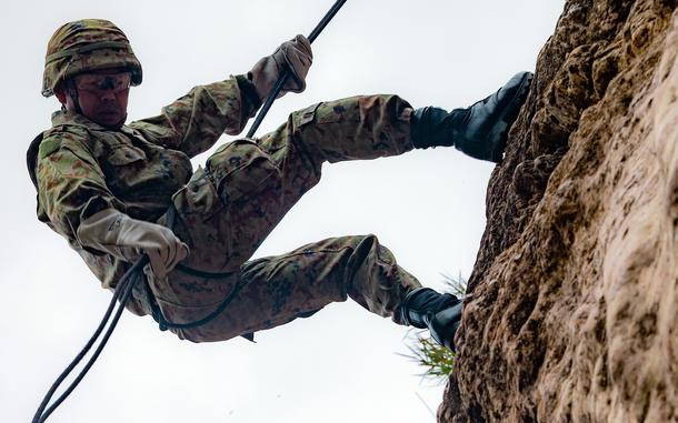 A member of Japan's Amphibious Rapid Deployment Brigade rappels down a cliff at the Jungle Warfare Training Center on Okinawa, Feb. 26, 2024.