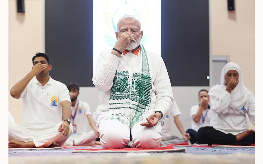 India’s Prime Minister Narendra Modi performs asana on International Day of Yoga in Srinagar. 