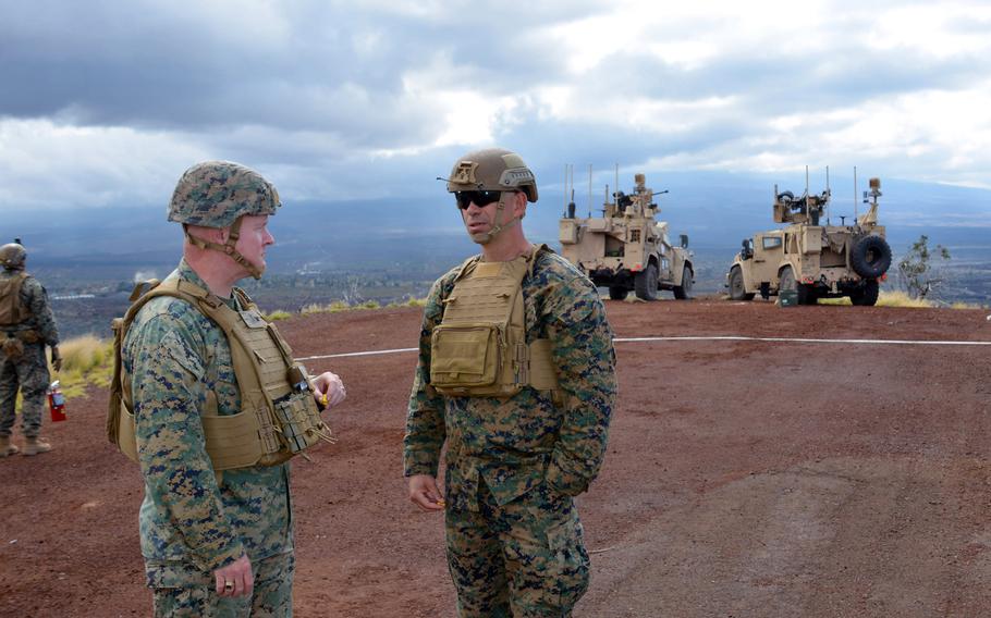 Col. John Lehane, commander of the 3rd Marine Littoral Regiment, left, and Lt. Col. Matthew Sladek, commander of the 3rd Littoral Anti-Air Battalion, chat near the Marine Air Defense Integrated System during live-fire training at Pohakuloa Training Area, Hawaii, Jan. 25, 2025.