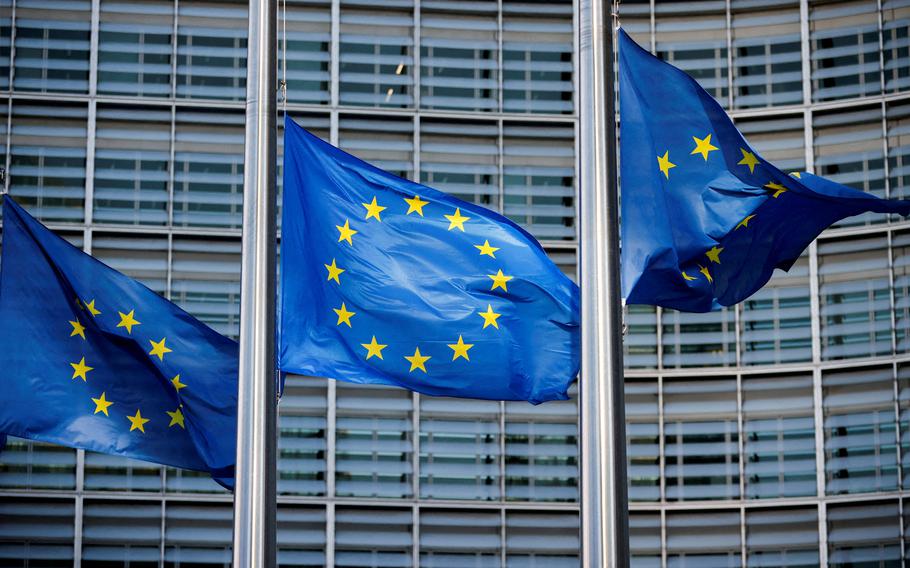 European Union flags fly outside European Commission headquarters in Brussels in March 2023.