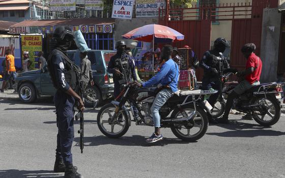 Police stop motorcyclists as they patrol in Port-au-Prince, Haiti, Friday, Aug. 23, 2024. (AP Photo/Odelyn Joseph)