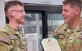 Col. Shane Mendenhall congratulates Spc. Jesse Martindale on his promotion to specialist in April 2024 at Fort Leavenworth, Kan. Martindale was promoted early through the Army Soldier Referral Program after a friend he referred joined the Army.