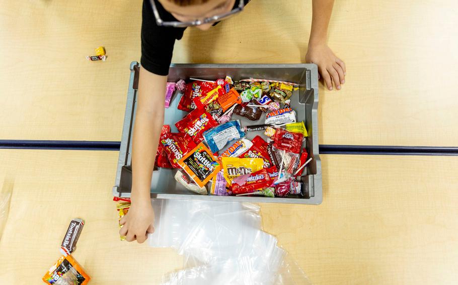 First and second grade students help fill bags of donated Halloween candy 