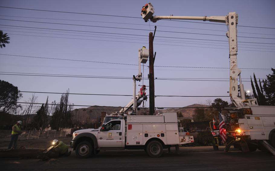 Southern California Edison workers service a utility pole