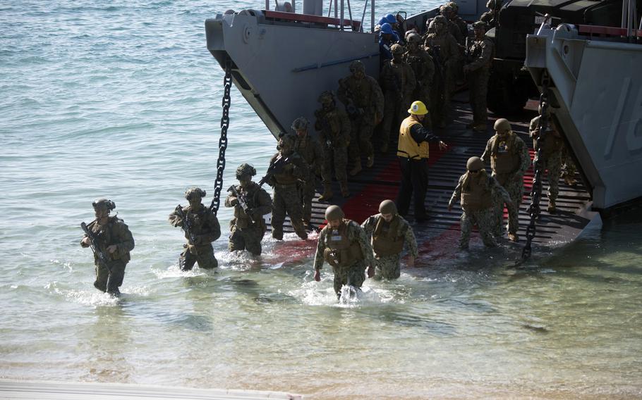 U.S. Marines disembark a landing craft during amphibious assault training.