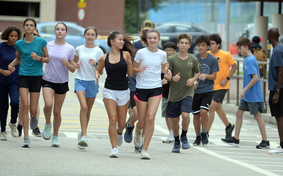 Osan freshman Charlotte Ng, middle, dark tank top, went unbeaten as an eighth-grader last year and would have been top 10 in every high school meet if eliglble.