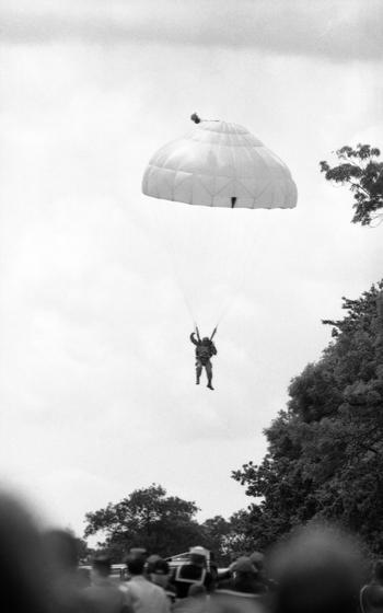 A paratrooper glides toward solid ground as he lands. Some 550 paratroopers reenacted the 101st Airborne Division D-Day jump. 
